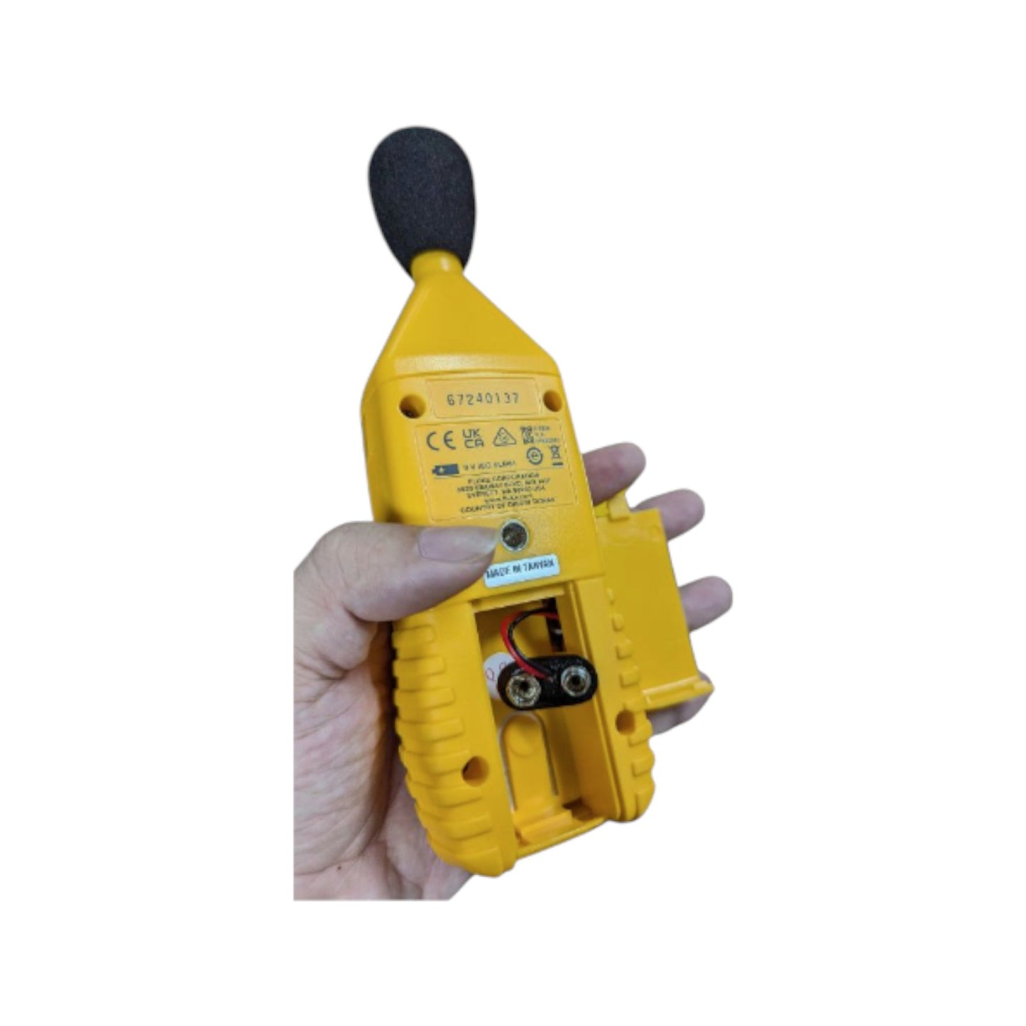 Fluke 945 sound level meter held in hand, showcasing its yellow design and user-friendly interface