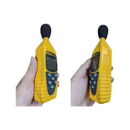 Fluke 945 sound level meter held in hand with display and controls visible for accurate sound measurement