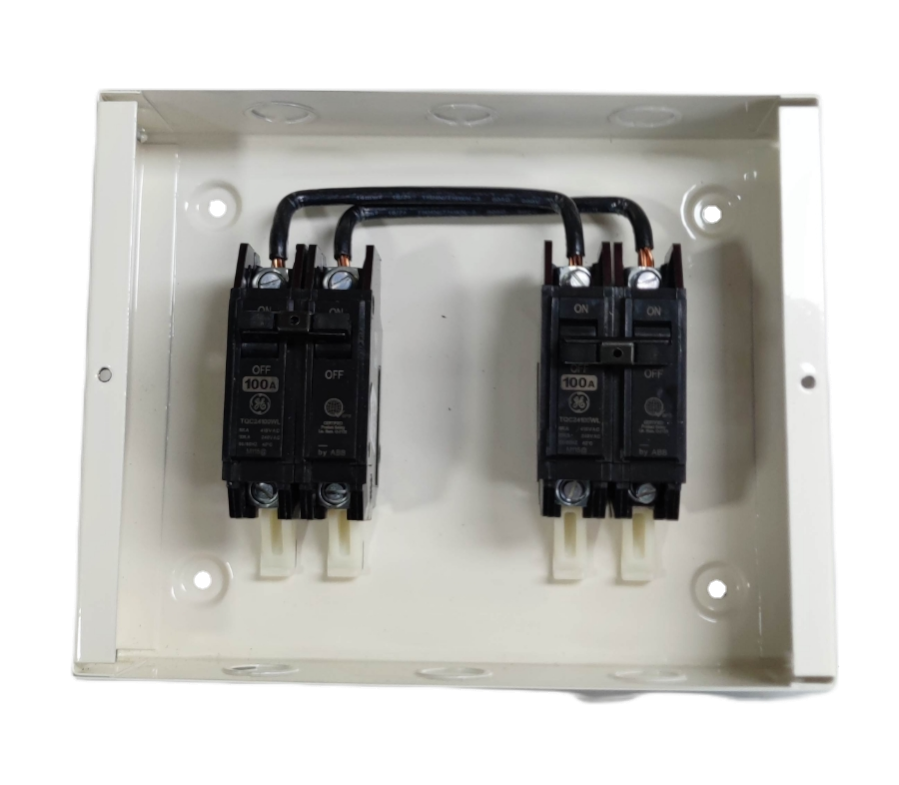 GE and Koten 100A manual transfer switch with black circuit breakers in a white metal enclosure