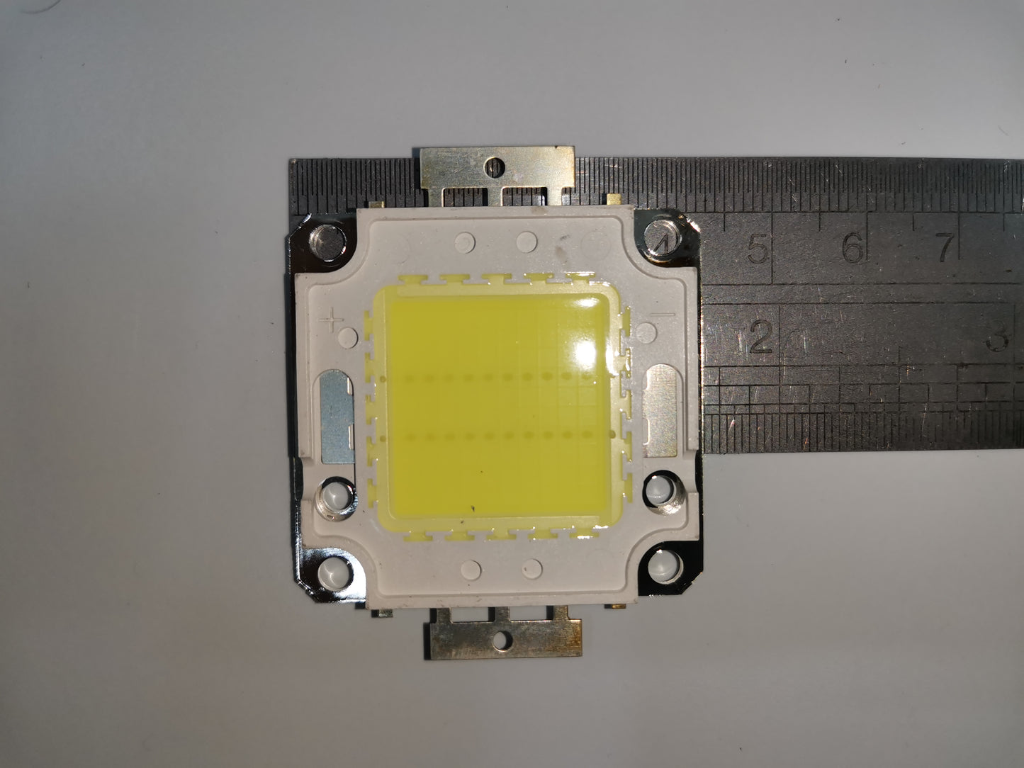 20w high power LED chip close-up with metal housing and ruler for size measurement