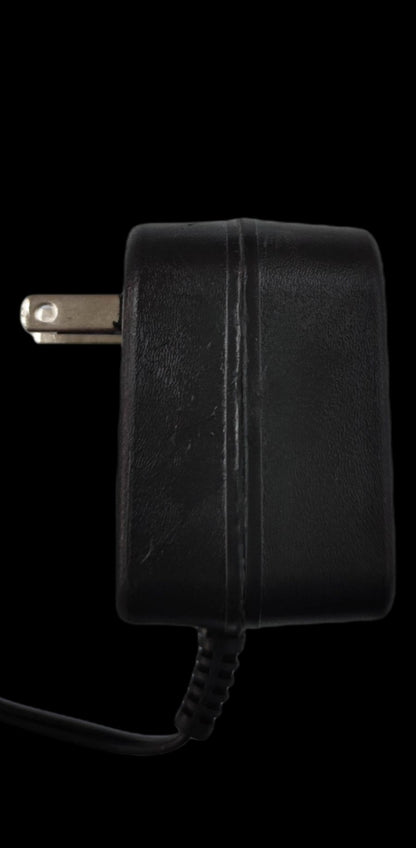 Black wall charger from China designed as a cellphone charger for Ericson old mode with plug and cable