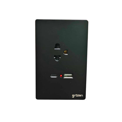 A black rectangular wall outlet cover plate with a US outlet, a USB-C port, a USB-A port, a small red indicator light, and the 'gräzen' brand name printed in white at the bottom right, shown against a plain white background.