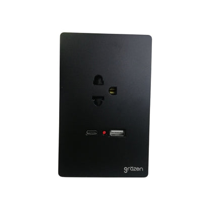 A black wall outlet cover plate with built-in USB-C and USB-A ports, featuring the 'grézen' brand logo in the bottom right corner, set against a plain white background.