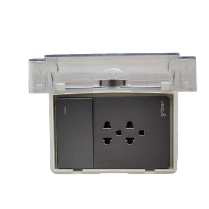 A wall-mounted electrical outlet socket with a transparent protective cover partially open, featuring a dark gray control panel and a three-pin power outlet on a white base.