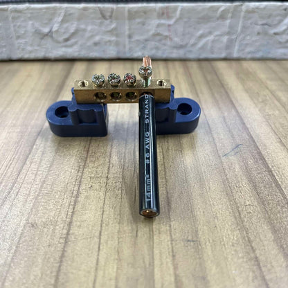 Grippes grounding bus bars 4 holes with connected wire mounted on black base for electrical circuitry