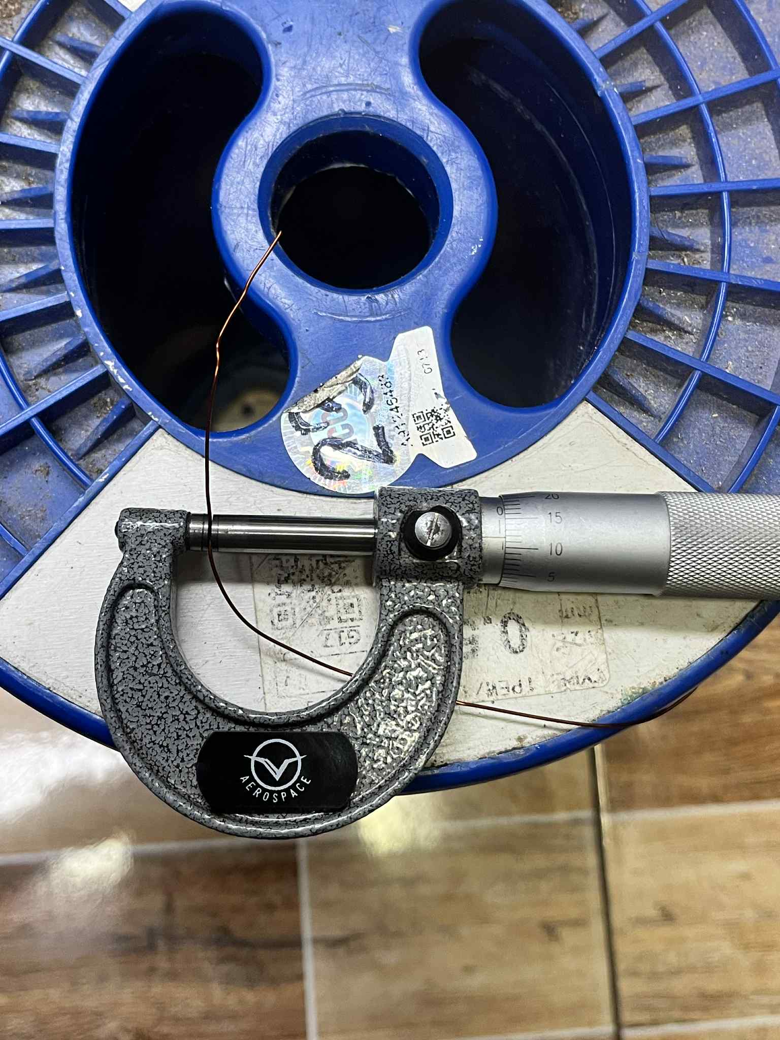 Philflex heavy Formix magnet wire AWG 23 400G being measured with a micrometer on a spool