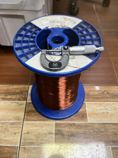 Philflex Heavy Formix magnet wire AWG 23 900G on a blue spool with measuring tool for precise gauge measurements