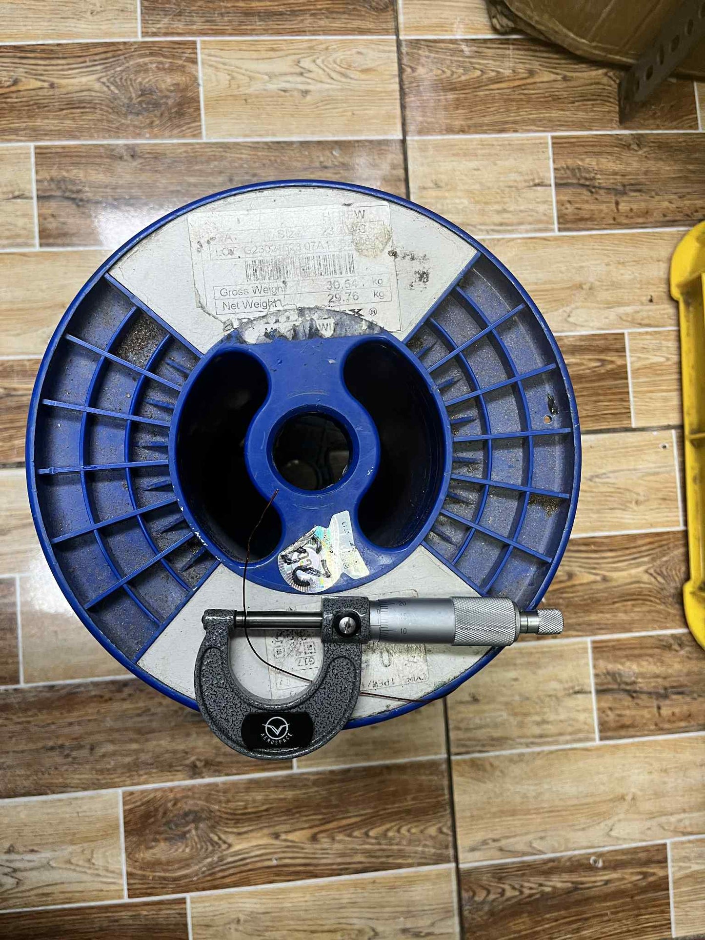 Philflex Heavy Formix magnet wire AWG 23 900G on a spool with a micrometer for measuring gauge