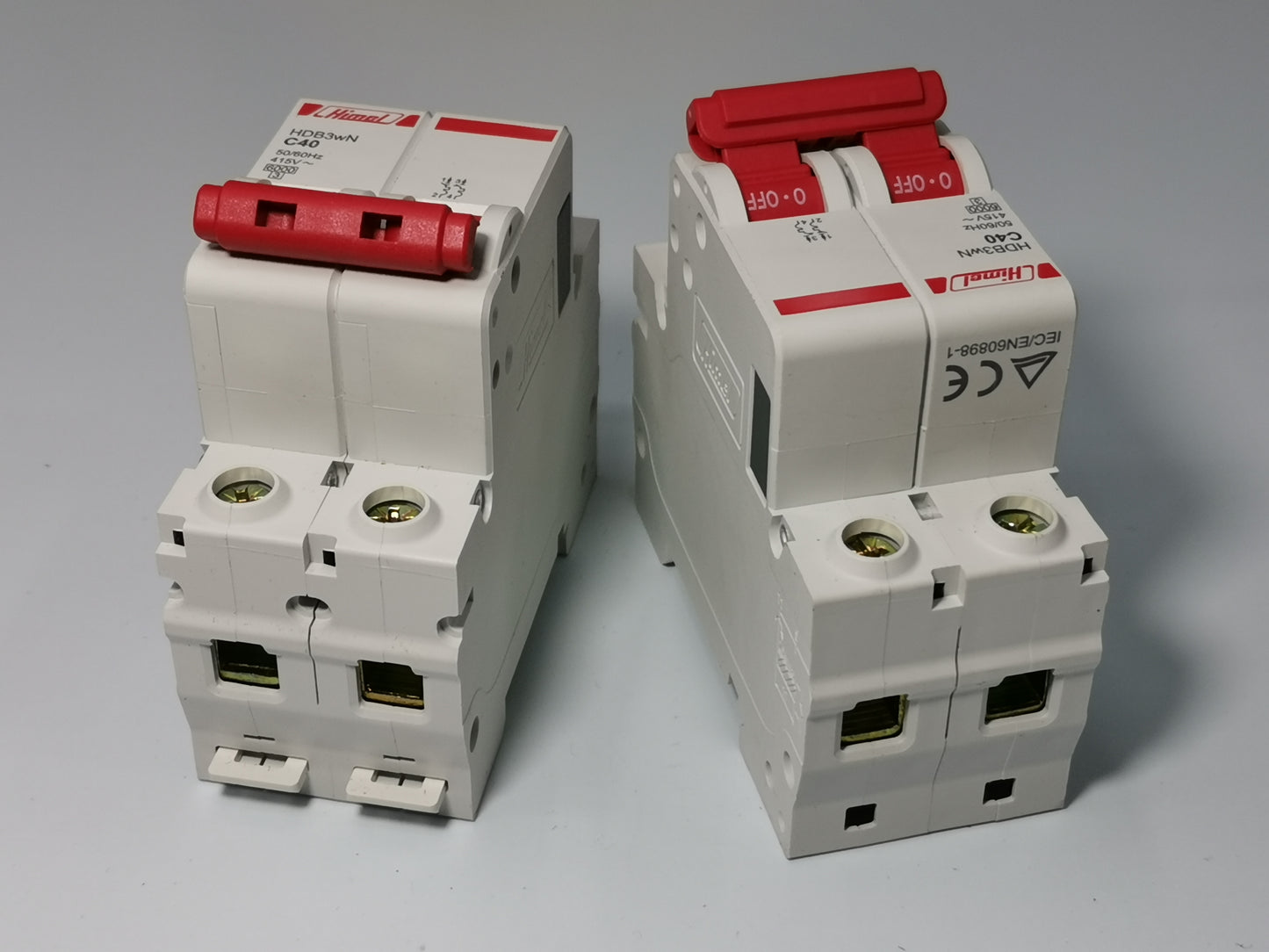 Two white Himel 40A MCB 2 pole circuit breakers with red toggle switches for DIN rail mounting
