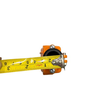 Auspicious industrial hoist push button switch in orange measuring approximately 2 inches with a yellow tape measure