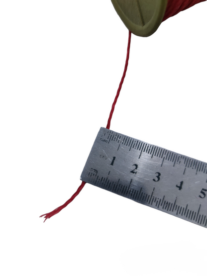 Red industrial nylon rope spool with measuring ruler for accurate gauge of thickness.