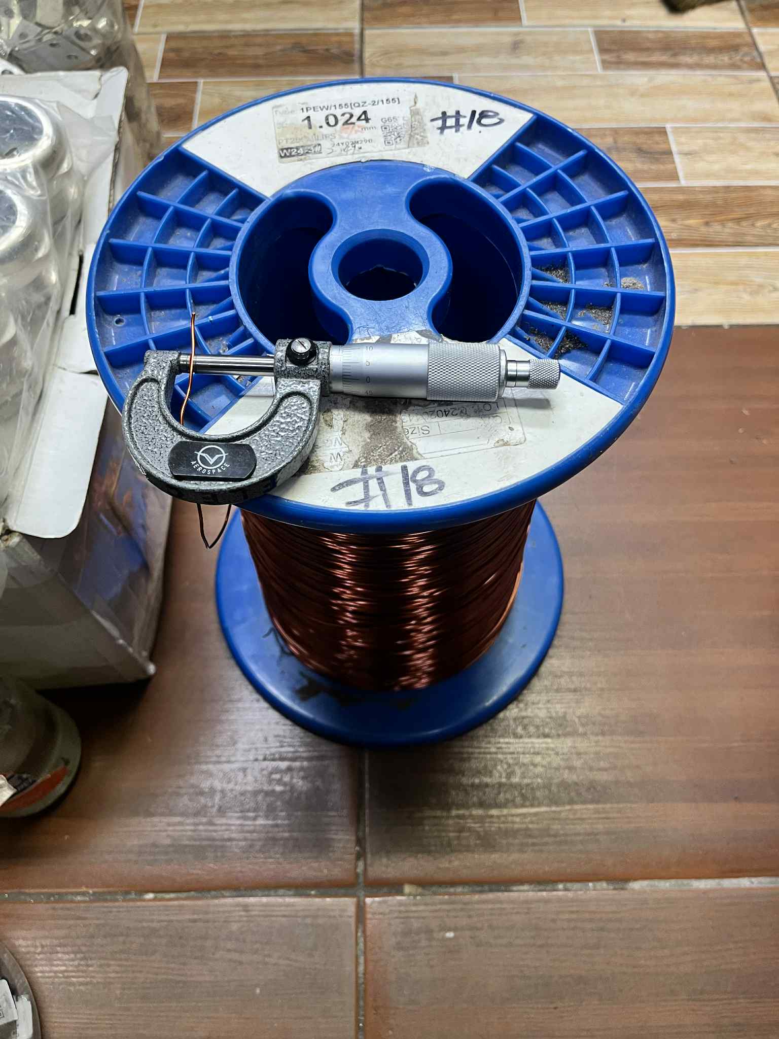 Philflex Magnet Wire AWG 18 100 Grams on a spool with a micrometer for precise measurements