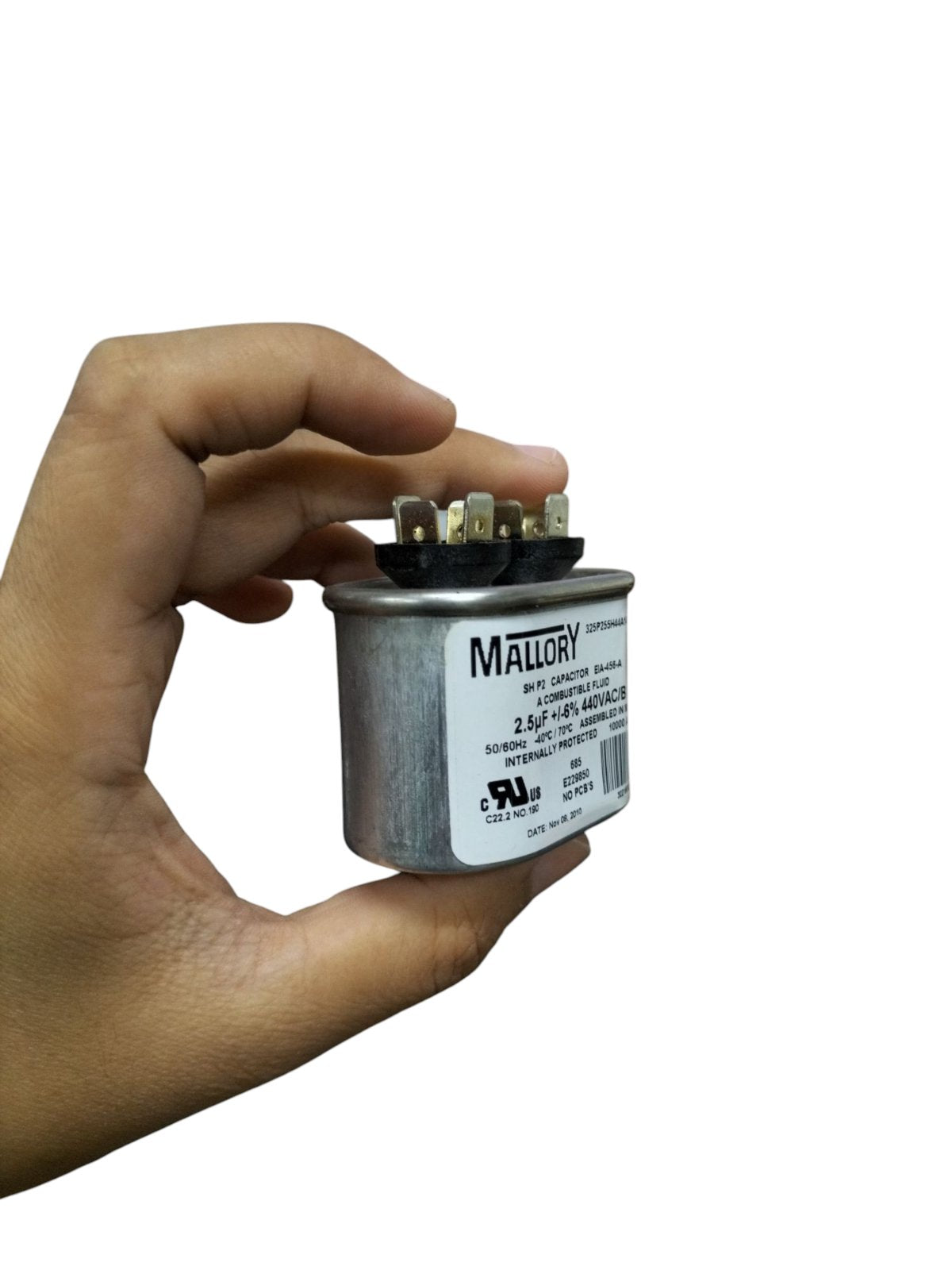 Mallory 440V running capacitor held in hand, ideal for electrical applications and motor use