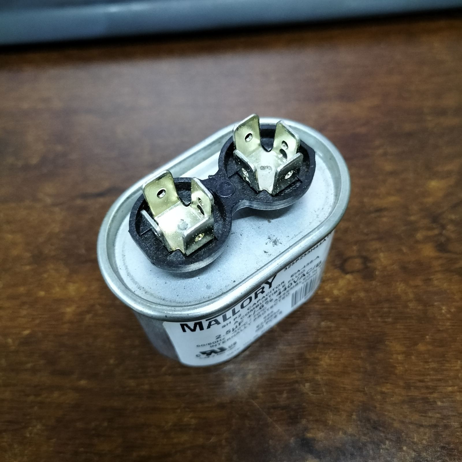 Mallory 440V running capacitor viewed from the top showing dual terminals for electrical connections