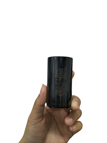 Mallory Electric Motor Start Capacitor held in hand for electrical circuitry and parts