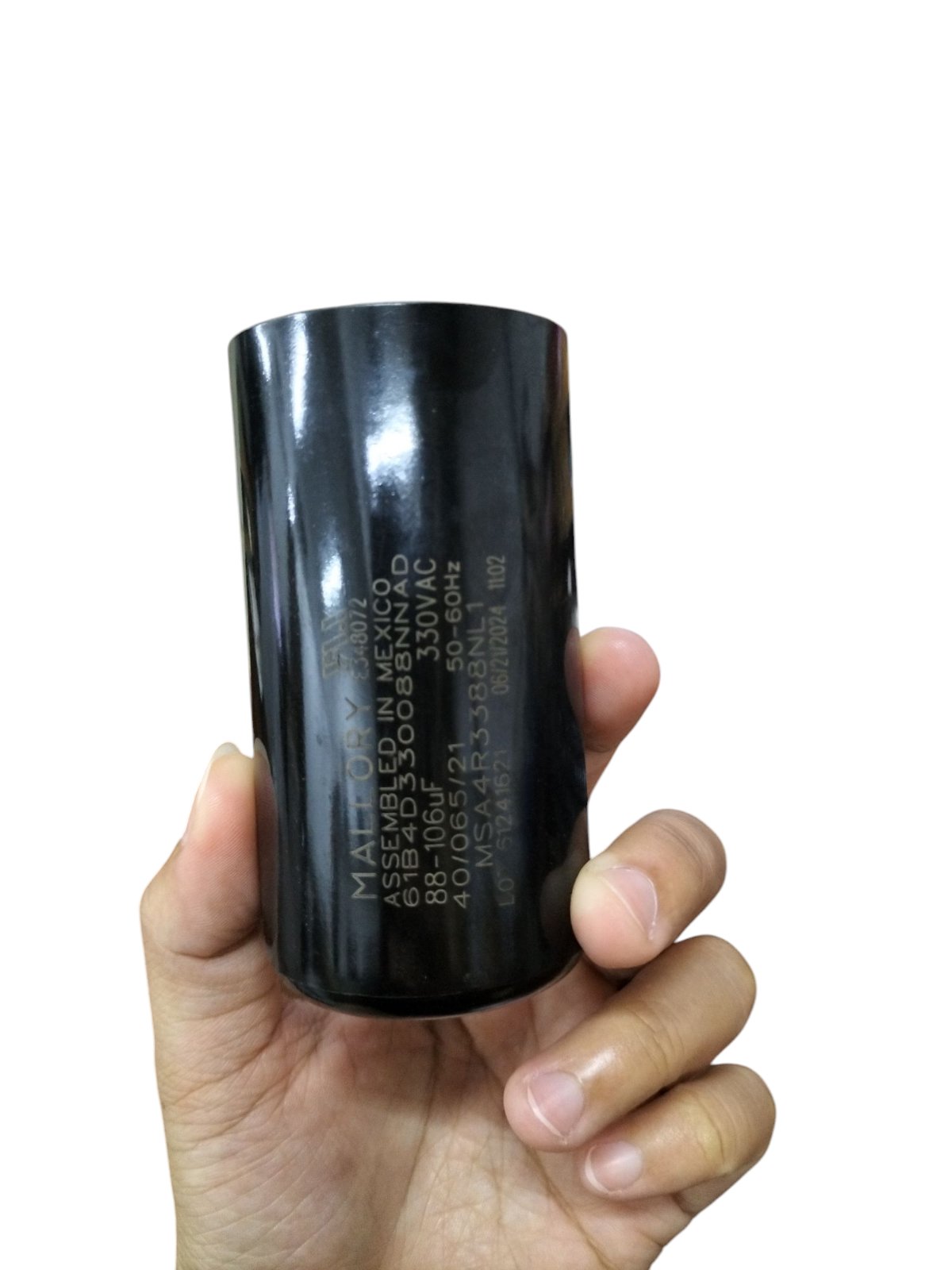 Mallory Starting Capacitor 88 to 106UF 330V in Black Cylinder Held in Hand