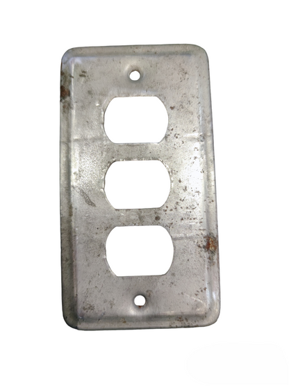 Rusty metal switch cover 3 gang with three rectangular openings for switches or plugs