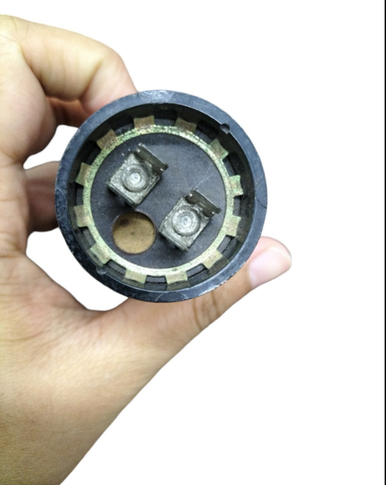 Motor capacitor 233-280UF 165V shown in hand, with connection terminals visible for installation