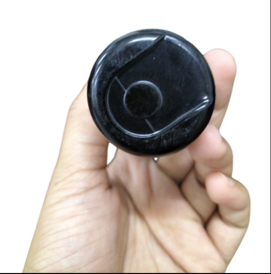 Hand holding a Motor Capacitor 324-389uf 165V showcasing the top view of the part