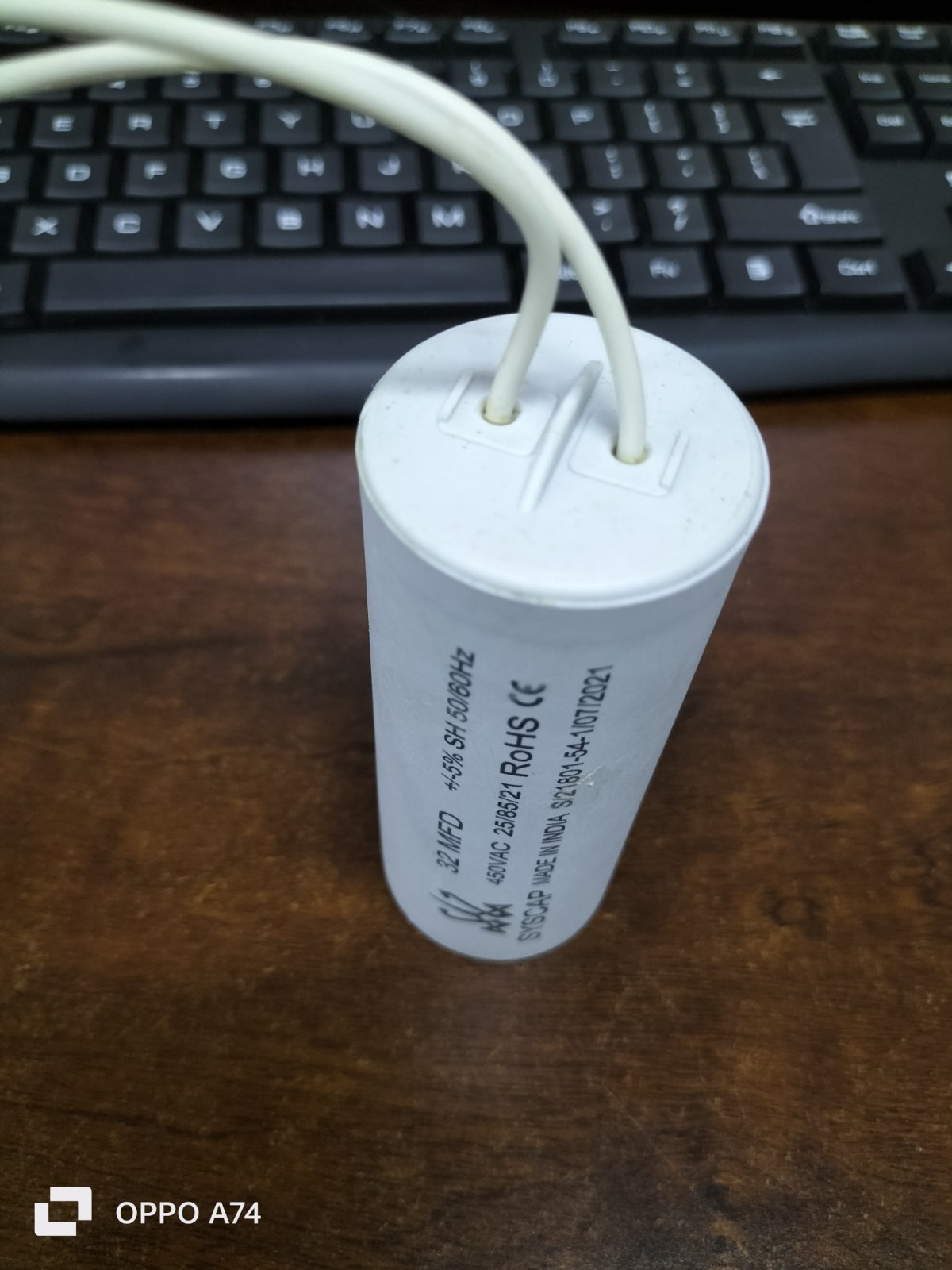 Syscap white cylindrical motor capacitor with two wires
