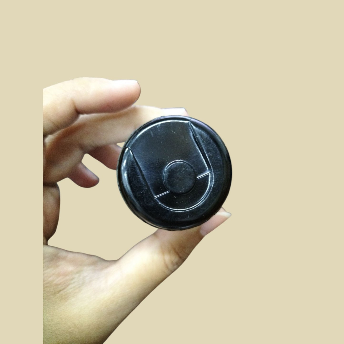 BMI motor start capacitor 53-64UF 165V held in a hand for electrical applications