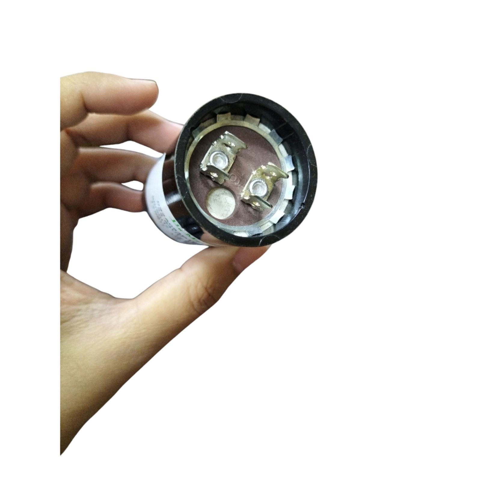 BMI motor start capacitor 53-64UF 165V held in hand with visible internal terminals