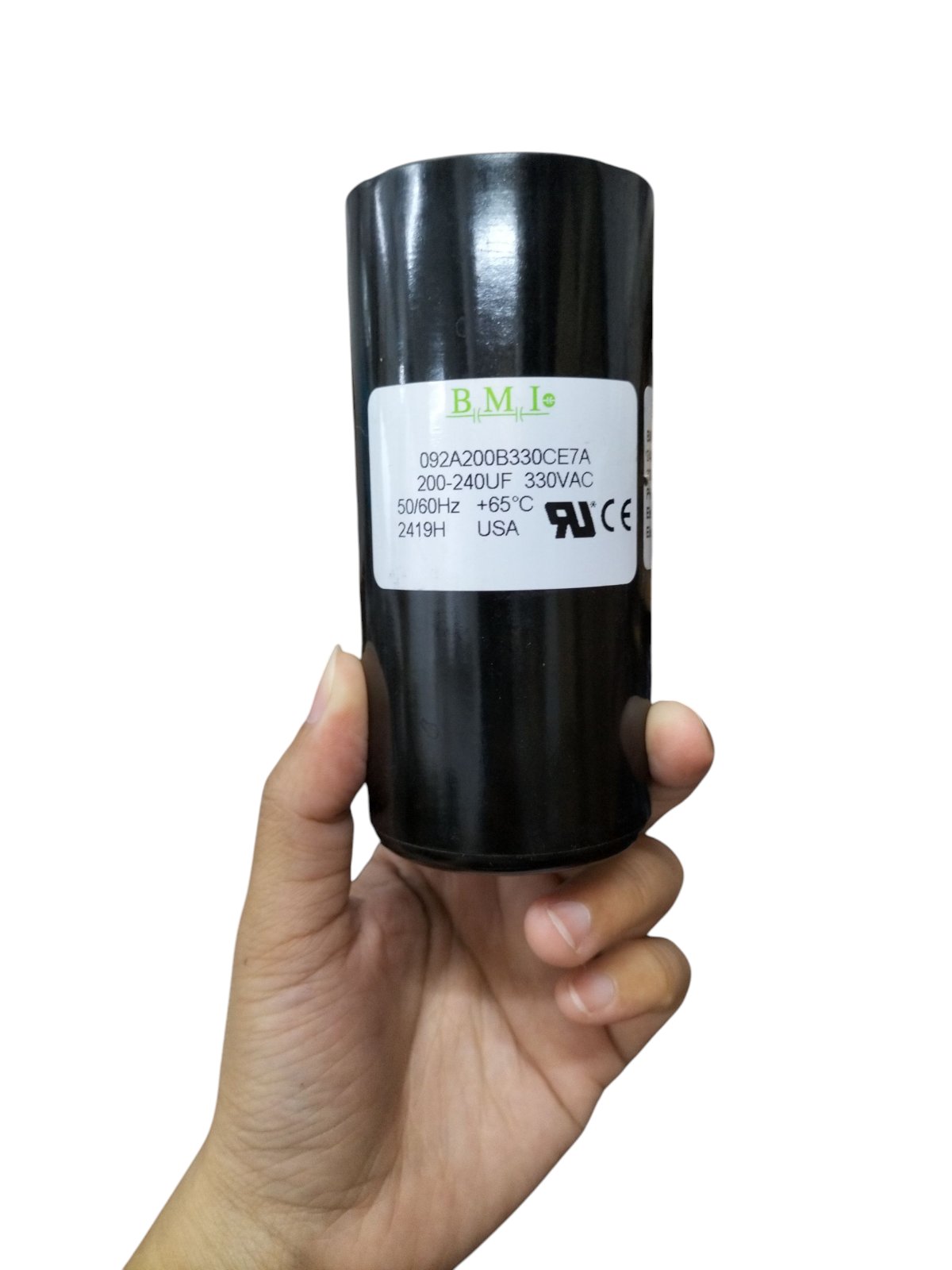 BMI Motor Starting Capacitor 200-240uF, 330VAC, handheld showing clear labeling and certification
