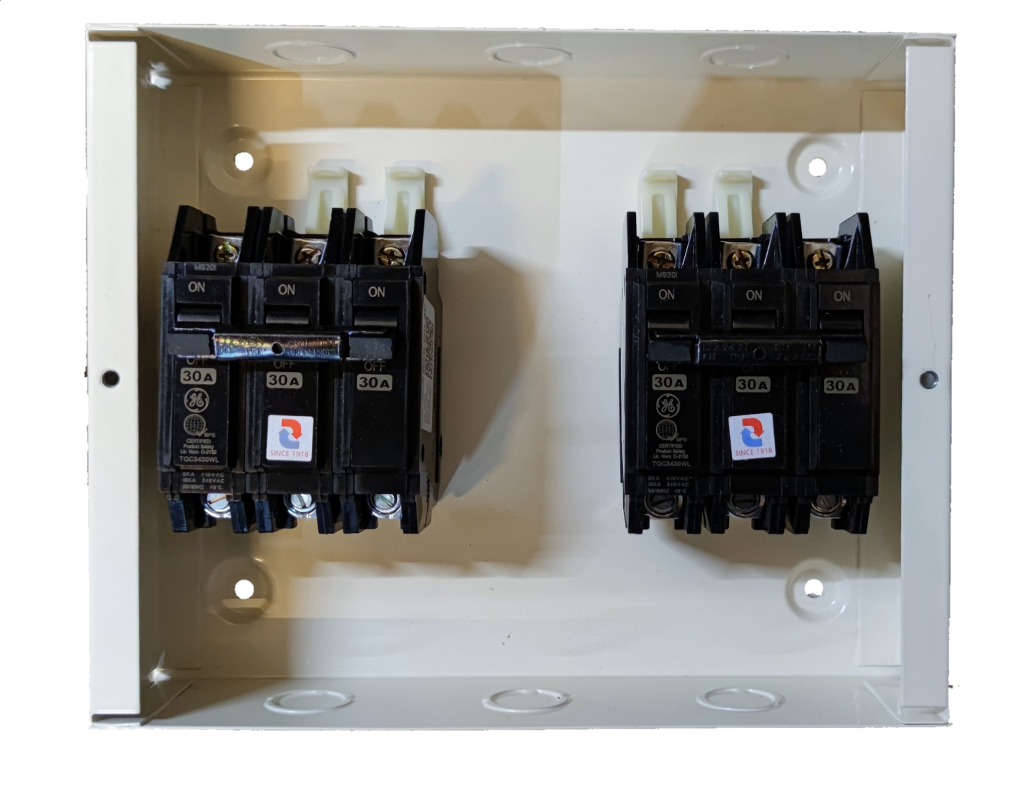 MTS 30A 3 Pole Single Phase electrical circuit breakers mounted in a white metal panel box by Koten and GE
