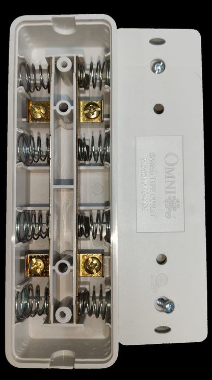 Omni surface type outlet showing internal springs and brass terminals for power connection