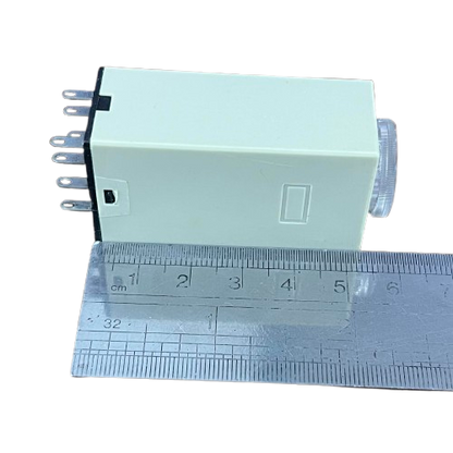 OMRON Timer Relay 30 seconds 8 pins 110V compact beige rectangular housing with adjustment dial and visible pins next to ruler
