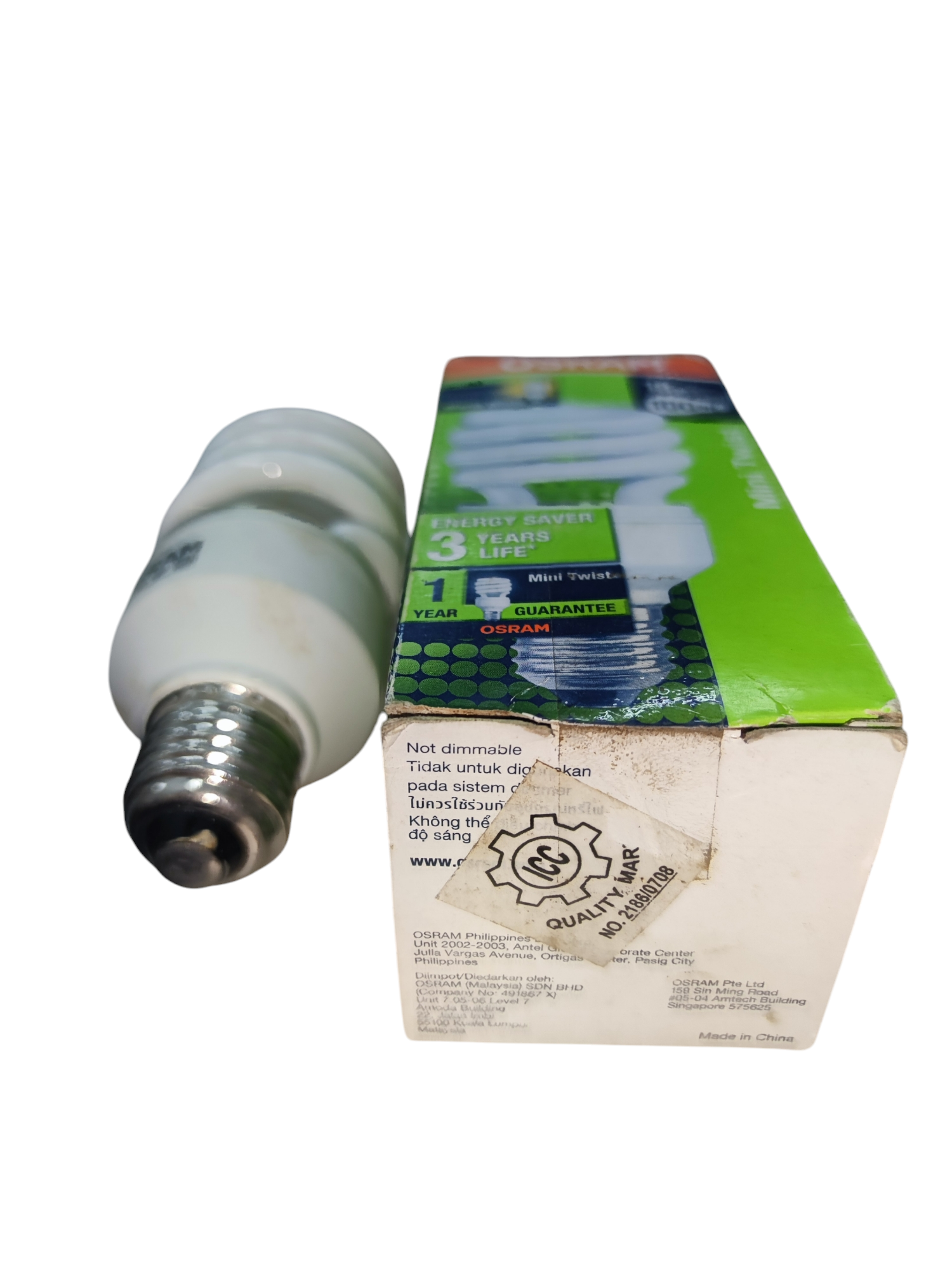 Osram Compact Fluorescent Lamp 11W E27 next to its green and white packaging box