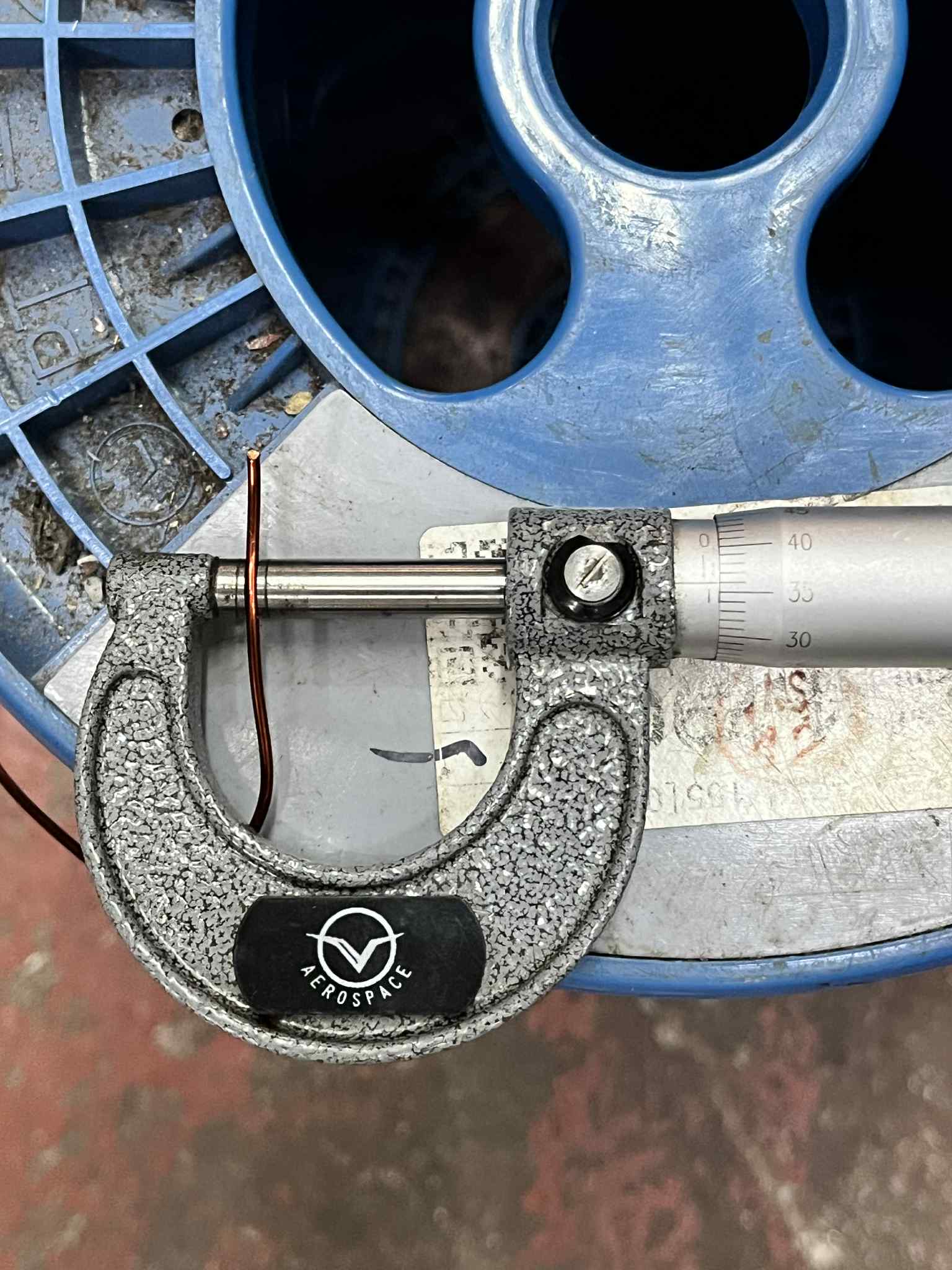 Philflex magnet wire AWG 16 measured with micrometer on a blue spool for precision work