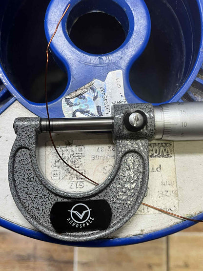 Philflex magnet wire AWG 23 800G being measured with a micrometer on a wire spool