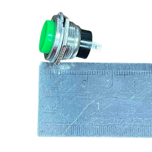 Push button 1A 220V green NO with a metallic casing and clear dimensions shown next to a ruler