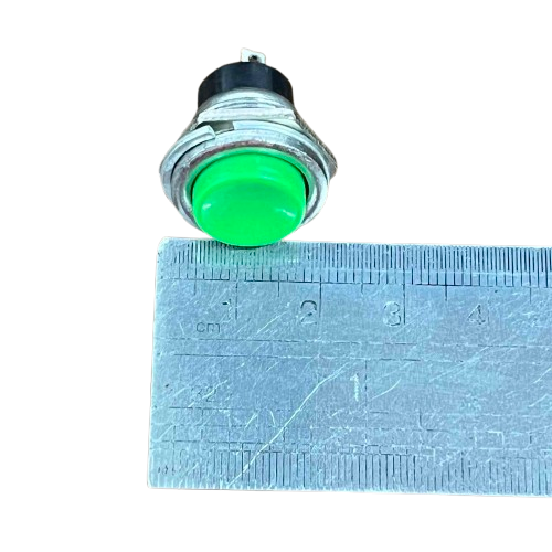 Push button 1A 220V green NO shown next to a ruler for size comparison