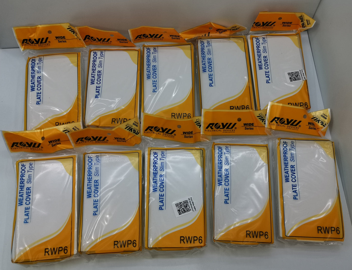 Royu Weatherproof Plate Cover packs with white covers in orange and white packaging for switches and plugs