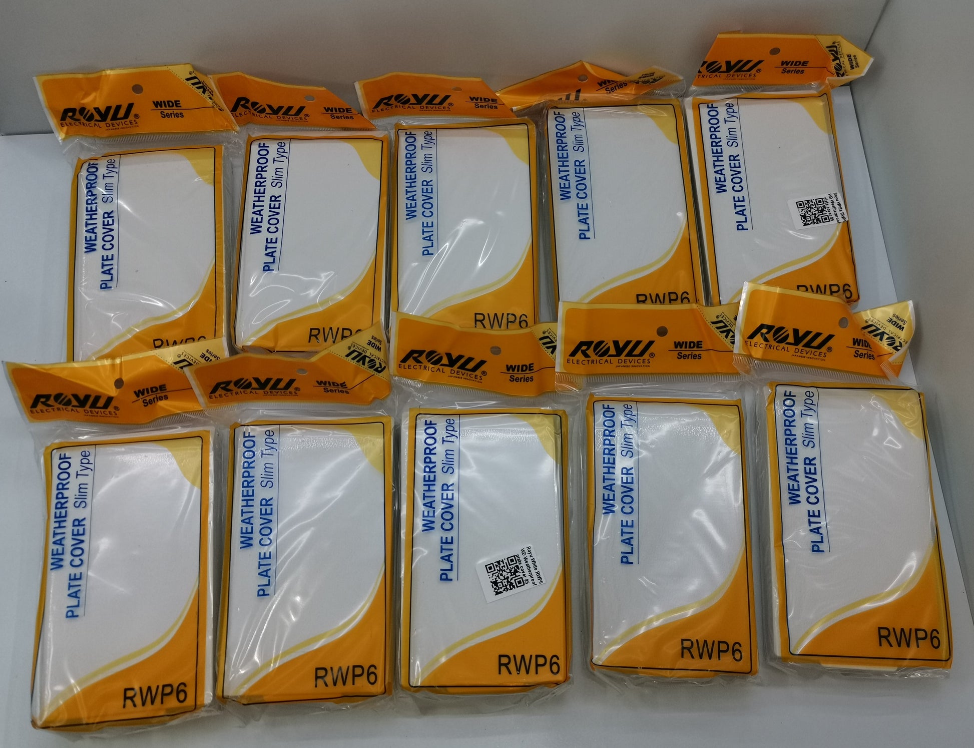 Royu Weatherproof Plate Cover packs with white covers in orange and white packaging for switches and plugs