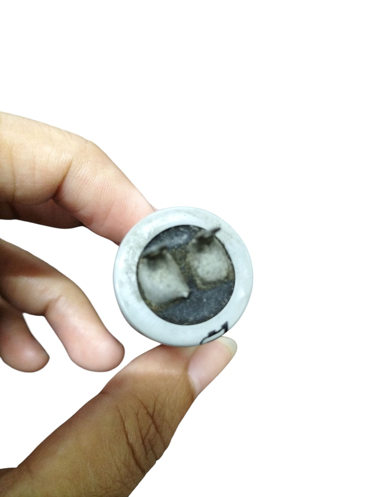 Hand holding a 350V AC Motor Running Capacitor showcasing its compact design