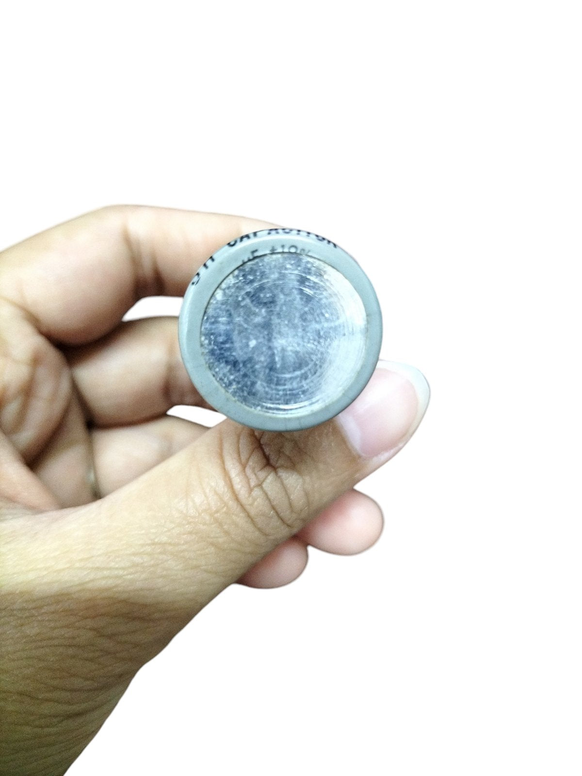 Hand holding a 350V AC Motor Running Capacitor with a visible label for electrical components