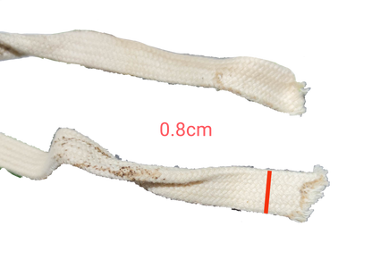 Close-up of white Shoe Thread 8mm x 3 Meters showing texture and frayed ends on black background