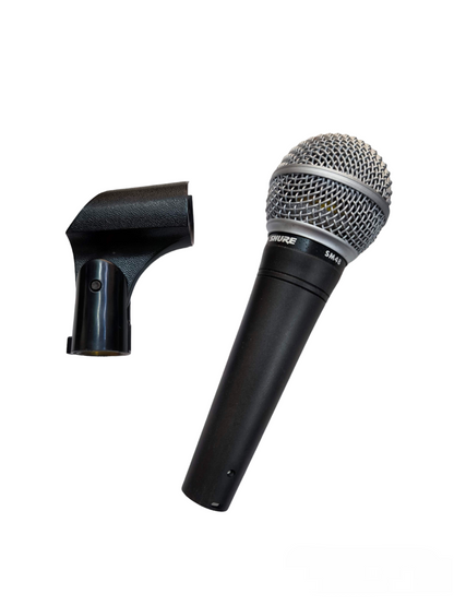 Shure Microphone Condenser with metal grille and black handle alongside black microphone clip