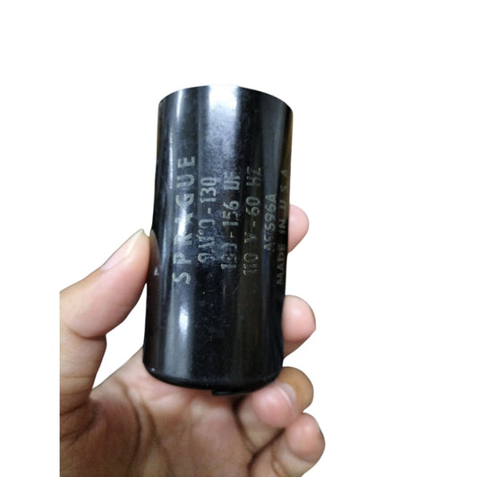 Spargue Motor start capacitor 130-156UF in a hand, designed for electrical circuit applications