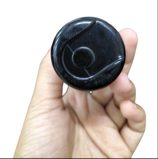 Hand holding a BMI Starting Capacitor 378-455uf 250v with a black cylindrical design.