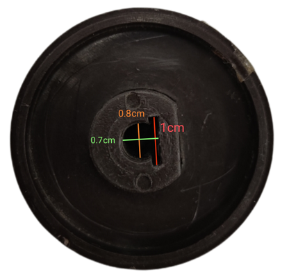 Black stove knob for electric stove with measurements on a dark background