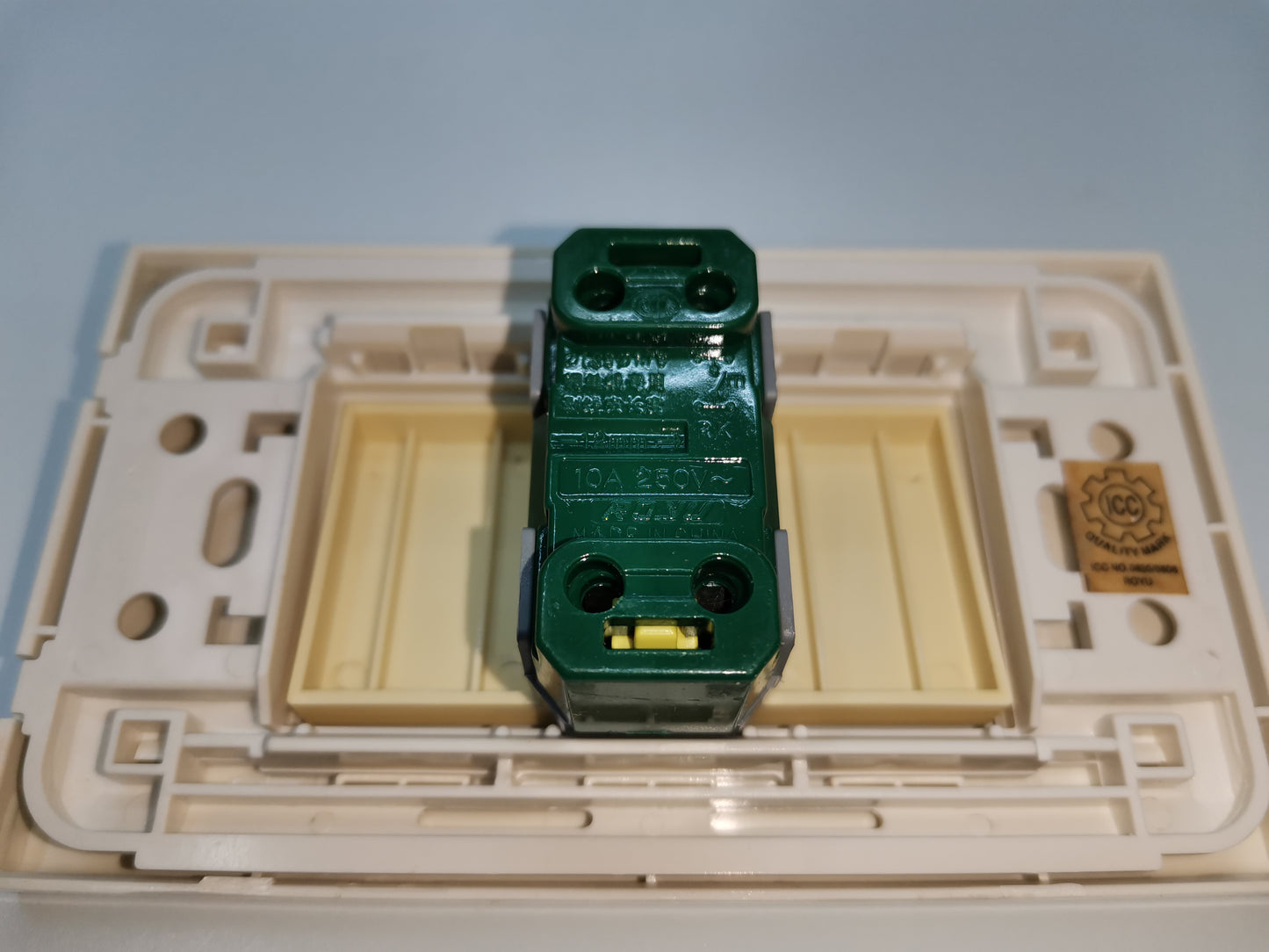 Royu Switch 1gang Flush Type with Led showing back wiring and mounting frame in beige and green