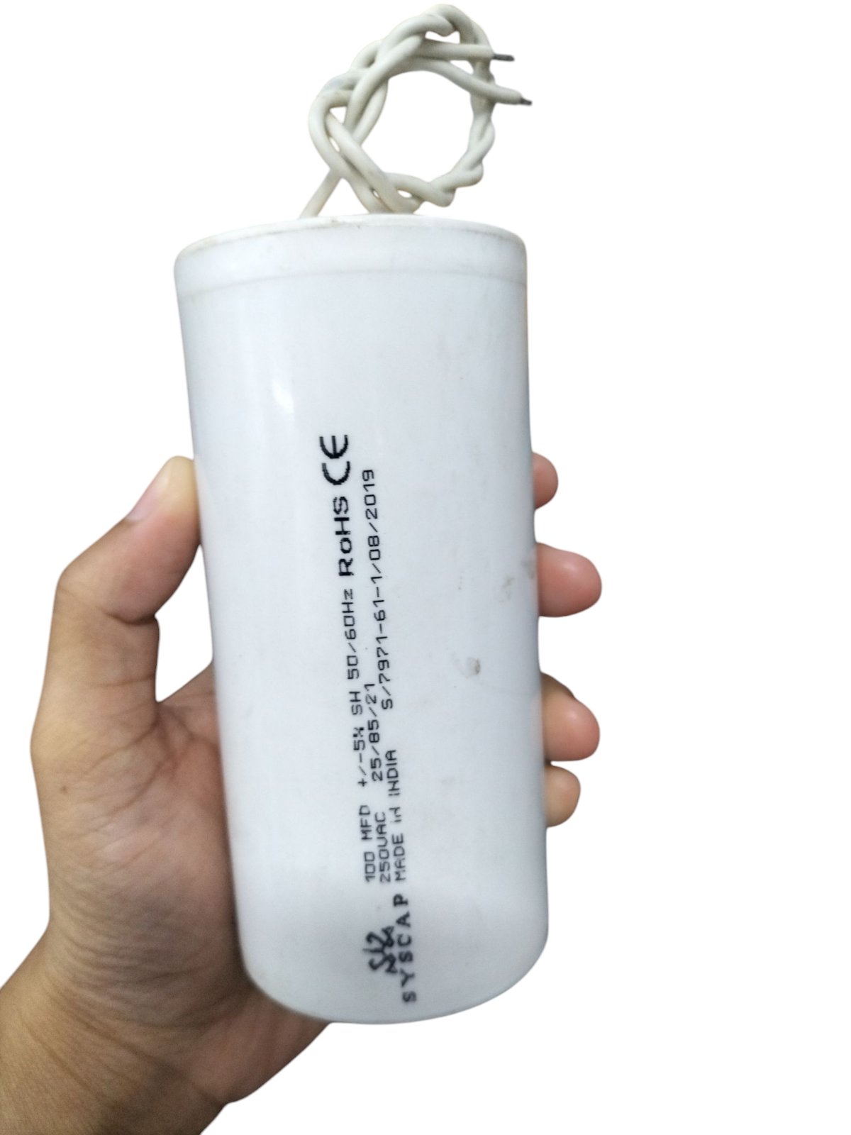 SYSCAP 100MFD 250V AC Motor Running capacitor held in hand, ideal for motor applications