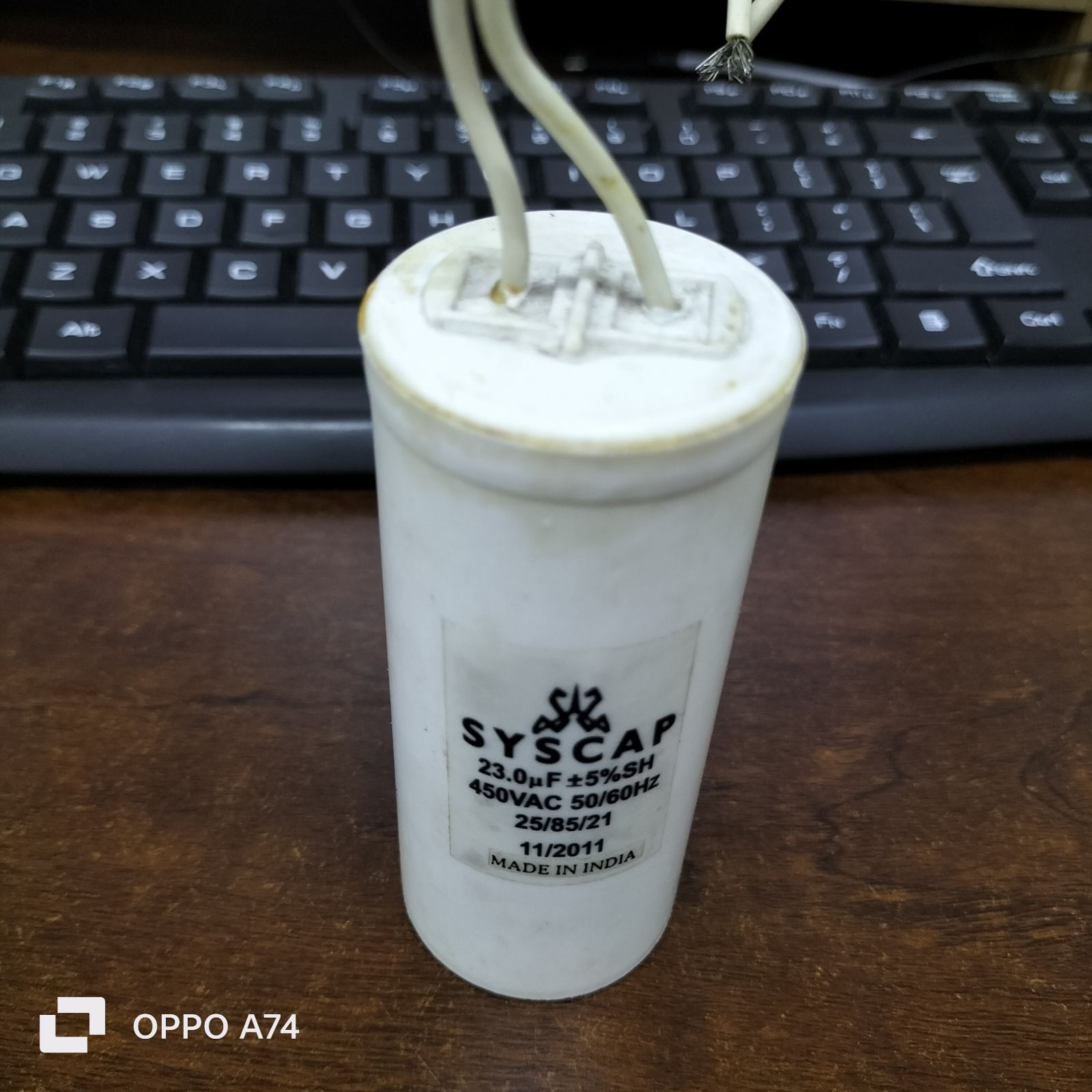 Syscap 23MFD 450VAC motor capacitor white cylindrical electrical component with wires