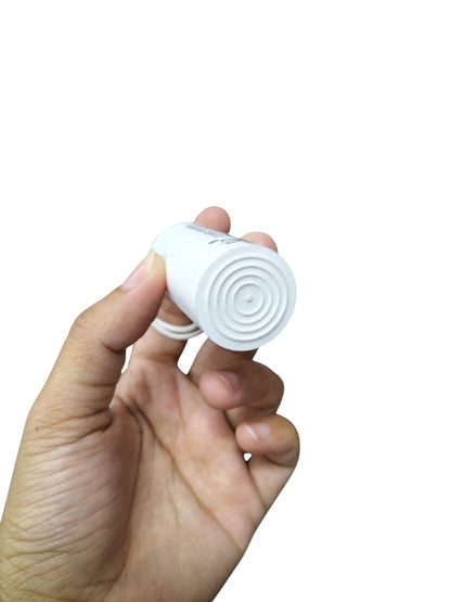 Syscap 250V AC motor running capacitor held in hand with a compact design for electrical applications