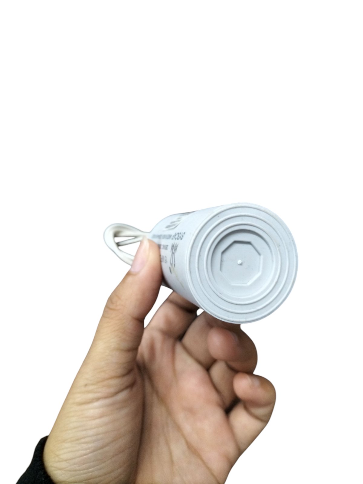 Hand holding a Syscap 2MFD 450V AC Running Capacitor for electrical applications