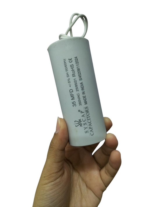 Syscap 35MFD 350 VAC Running Capacitor held in hand for electrical circuitry applications